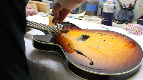 Luthier Setting Up Electric Guitar